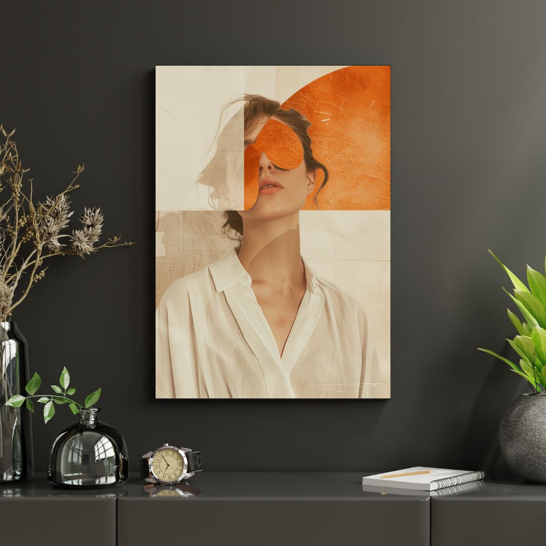 Framed modern woman portrait with orange accents on dark wall, styled with natural elements.