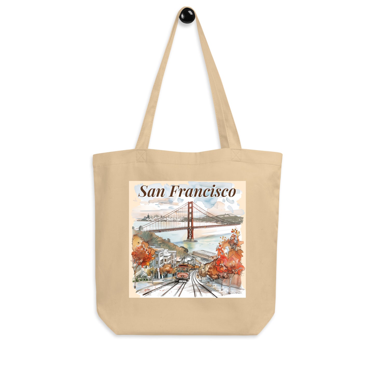 Tote bag with San Francisco design hanging on a black wall hook