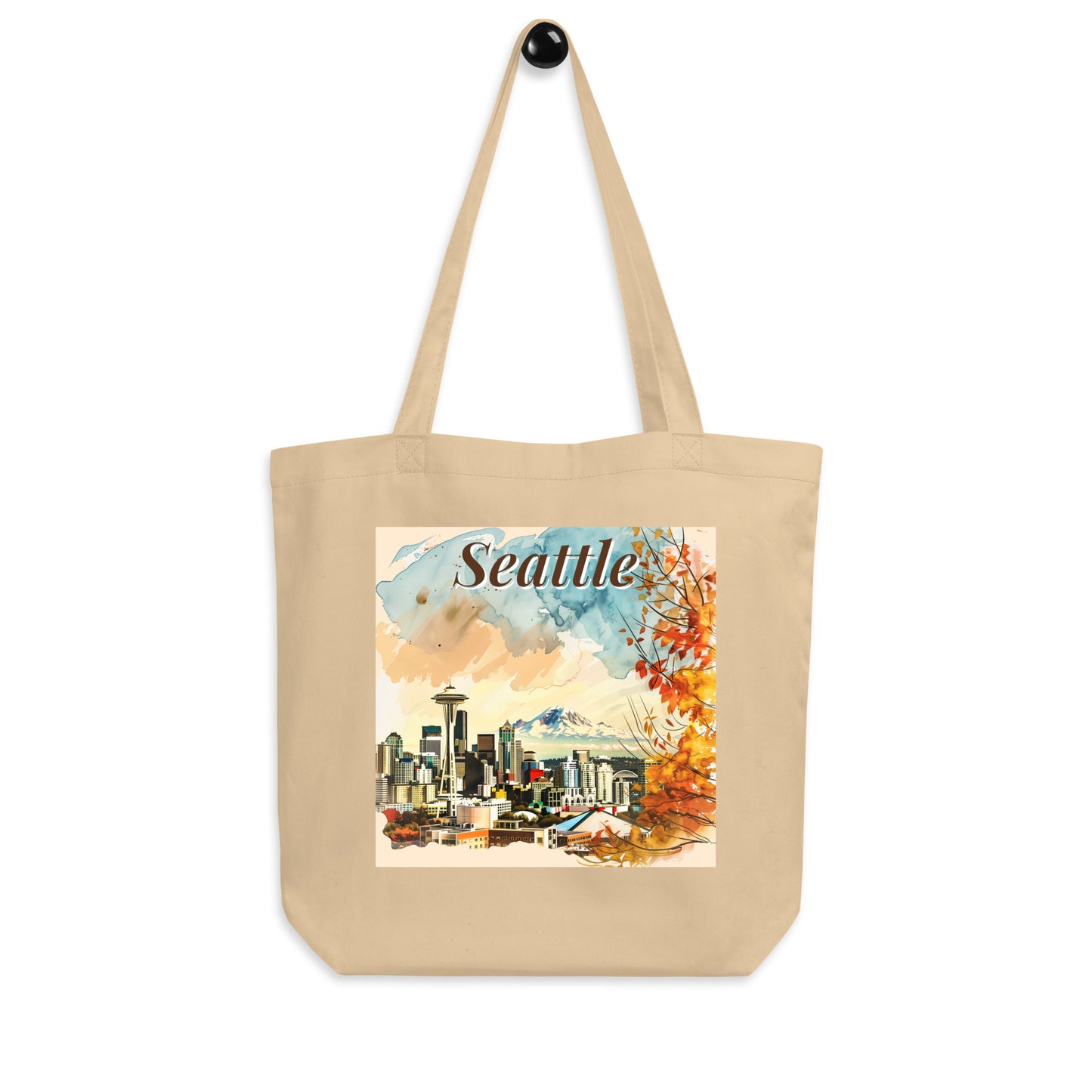 Tote bag with Seattle print hanging on a hook, front view against a light background.