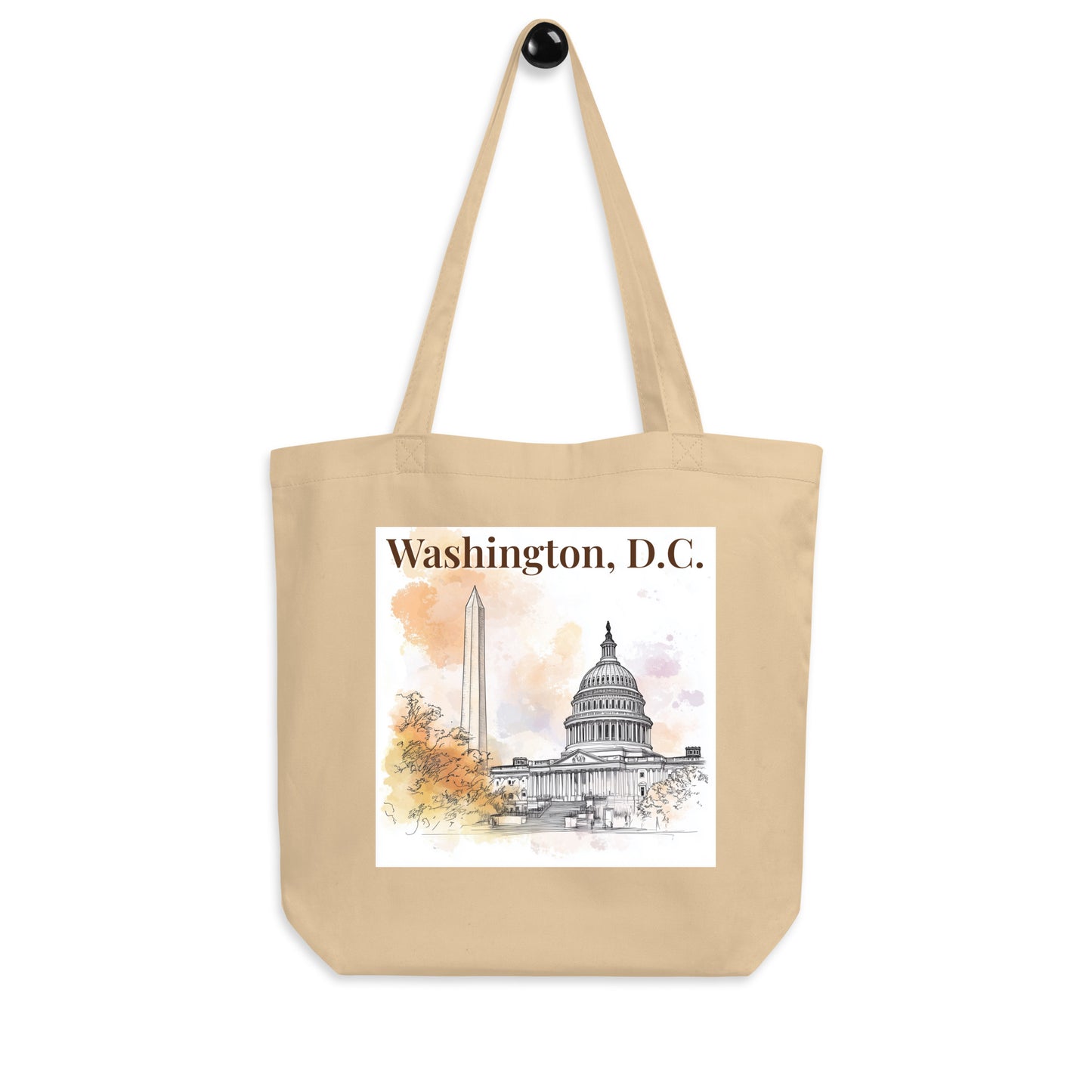 Straight-on product shot of the beige tote bag with Washington, D.C. watercolor print featuring iconic architecture. Simple background for clean presentation.