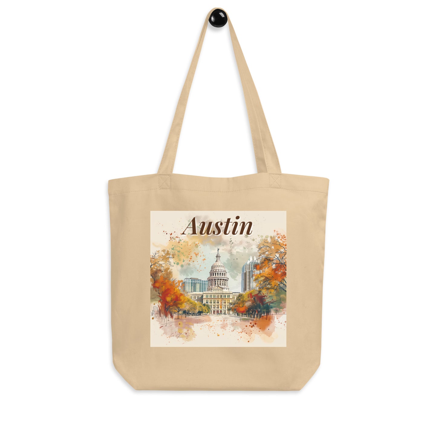 Product display of Austin city tote bag on hook, showing long straps and detailed print with soft autumn-inspired colors.