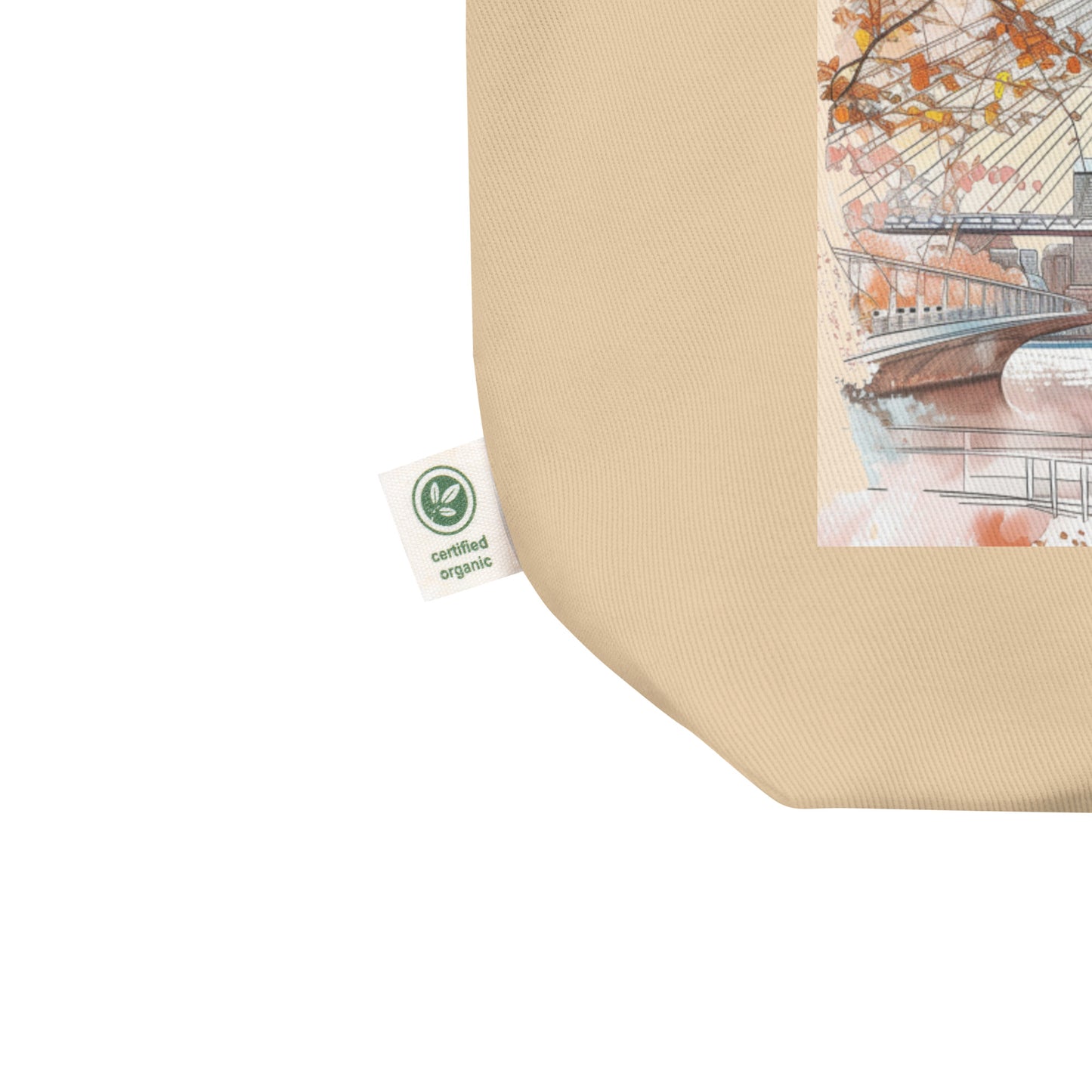 Close-up of certified organic cotton label on beige tote bag corner, showcasing eco-friendly material used in the Boston art tote.