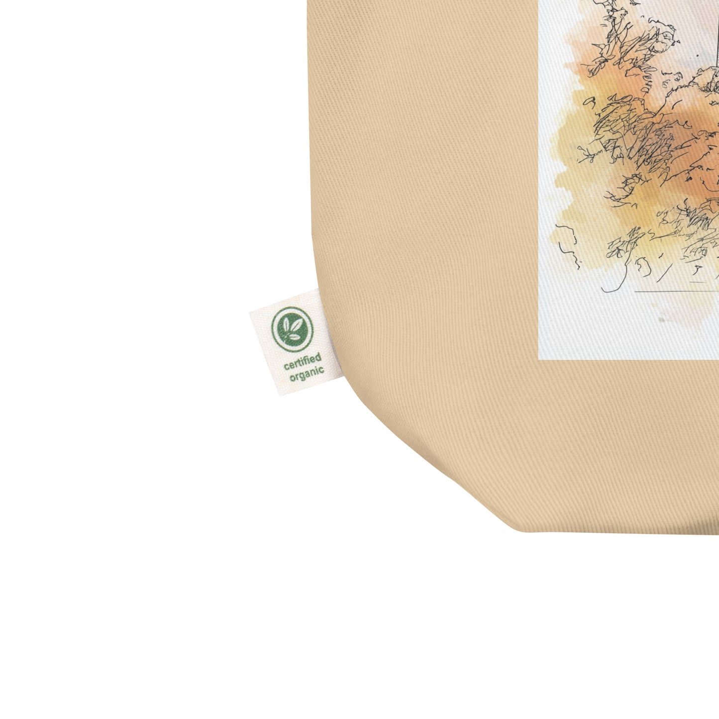 Detailed view of the bottom corner of the tote bag showing the “Certified Organic” label tag and part of the Washington, D.C. artwork printed on the canvas.