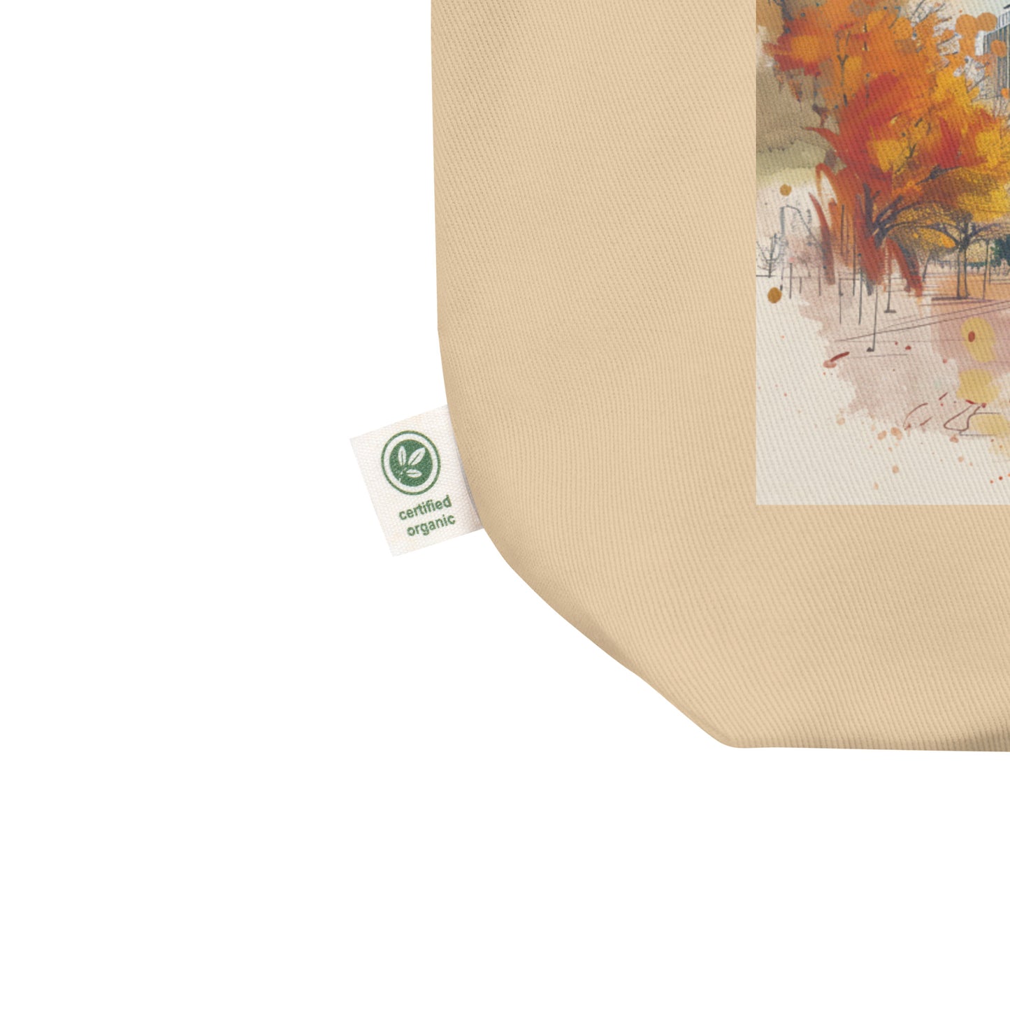 Close-up of the corner of the beige Austin tote bag, highlighting the certified organic cotton tag and durable stitching.