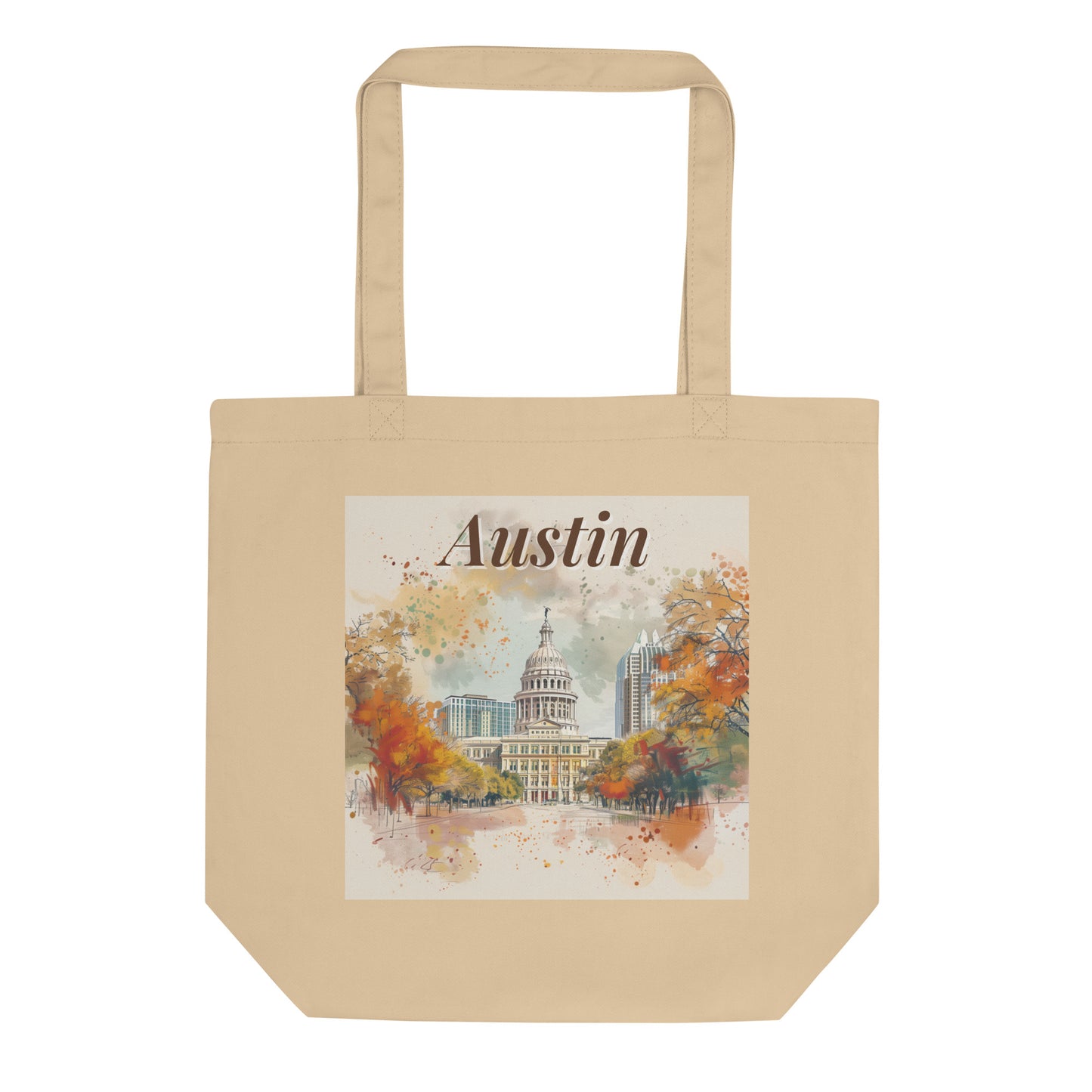 Flat-lay product image of the Austin organic cotton tote bag, featuring watercolor-style illustration of the Texas Capitol and fall foliage
