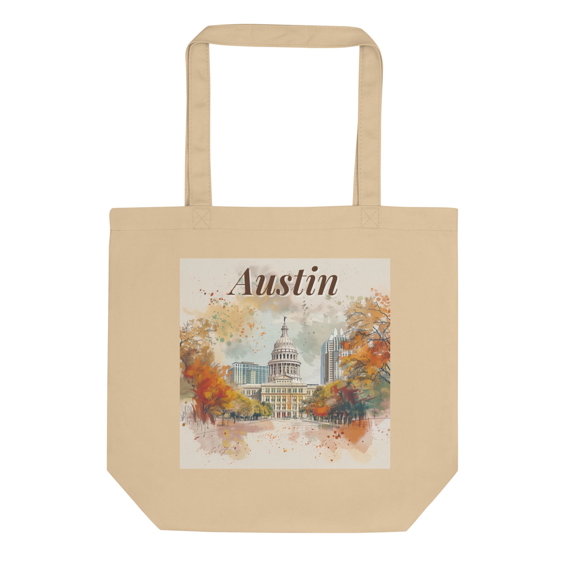 Flat-lay product image of the Austin organic cotton tote bag, featuring watercolor-style illustration of the Texas Capitol and fall foliage