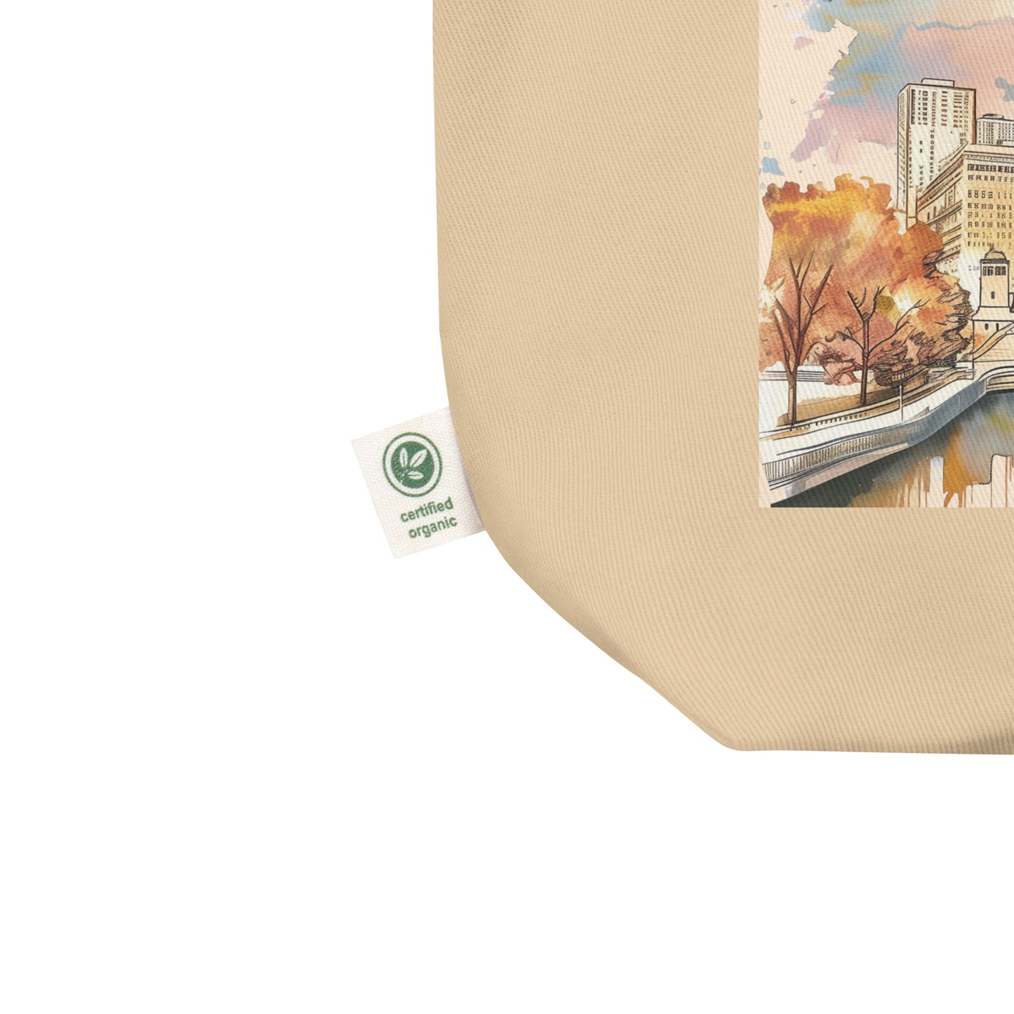 Close-up of tote bag corner showing Chicago design and organic cotton certification tag.