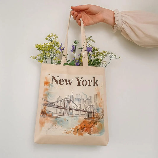 Hand holding New York tote bag filled with flowers
