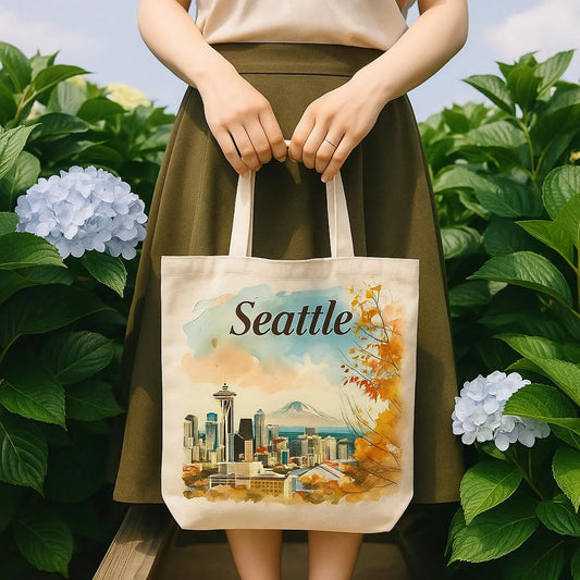 Seattle tote bag held by a woman standing in blooming hydrangeas, garden-style composition.